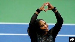 Serena Williams, of the United States, makes a heart sign to fans after losing to Ajla Tomljanovic, of Austrailia, during the third round of the US Open tennis championships, Sept. 2, 2022, in New York. 