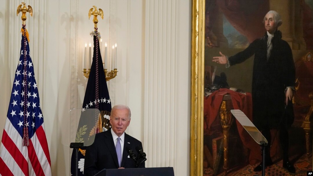 FILE - President Joe Biden speaks before signing an executive order in the East Room of the White House under the portrait of George Washington, May 25, 2022. The Washington portrait has been at the White House since 1800, and was removed to save it from a fire during the War of 1812.
