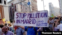 Demonstrators take part in a protest against Madrid's new conservative People's Party municipal government plans to suspend some anti-car emissions policies in the city center, June 29, 2019. 