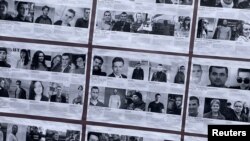 Photos of what organizers said were people detained by police in Belarus appear on a placard during a protest against the detention of political prisoners and in support of victims of police violence in Belarus, in Toronto, Ontario, Canada April 3, 2021. 