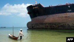 Un pêcheur devant un paquebot sur les Iles Marshall, près de la Tanzanie, le 13 février 2016.