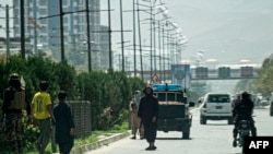 Taliban fighters (C) stand guard along a road near the Russian embassy after a suicide attack in Kabul, Sept. 5, 2022.