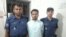 পুলিশের সাথে আটক ঝুমন দাশ। (ফাইল ছবি) 