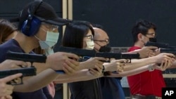 People shoot air soft guns at a private civilian training organization named Polar Light Training in New Taipei City, Taiwan on June 21, 2022. 