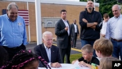 President Joe Biden talks to children before speaking at a United Steelworkers of America Local Union 2227 event in West Mifflin, Pennsylvania, Sept. 5, 2022, to honor workers on Labor Day.