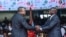 FILE - Outgoing Kenyan President Uhuru Kenyatta shakes hands with President William Ruto at the Moi International Sports Center, in Nairobi, Kenya, Sept. 13, 2022, during Ruto's inauguration.