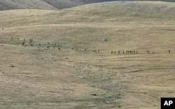 FILE - This image taken from a YouTube footage released by Armenian Defense Ministry on Sept. 13, 2022, shows Azerbaijanian servicemen crossing the Armenian-Azerbaijani border and approaching the Armenian positions.