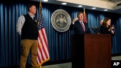 Mississippi Gov. Tate Reeves, center, announces the state imposed boil-water notice has been lifted in Jackson after nearly seven weeks, with Mississippi Emergency Management Agency executive director Stephen C. McCraney, right, and ASL interpreter Denee Smith, Sept. 15, 2022.