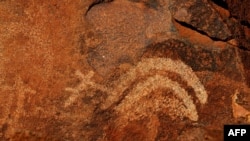 FILE - An ancient Aboriginal rock carving is shown in this photo taken on the Burrup Peninsula in the north of Western Australia, June 16, 2008.