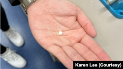 University of British Columbia research student Yigong Guo holds a small-sized insulin tablet. (Photo courtesy of Karen Lee/UBC)