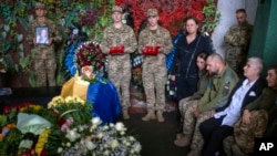 FILE: Friends and comrades-in-arms gather to bid farewell to Olga Simonova, 34, a Russian woman who was killed in the Donetsk region while fighting on Ukraine's side, in Kyiv, Ukraine, Sept. 16, 2022.