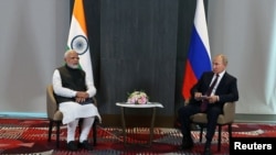 FILE - Russian President Vladimir Putin and Indian Prime Minister Narendra Modi meet at the Shanghai Cooperation Organization summit in Samarkand, Uzbekistan, September 16, 2022.