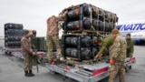 FILE - Ukrainian servicemen unpack Javelin anti-tank missiles, delivered as part of a U.S. security assistance package, at the Boryspil airport, outside Kyiv, Ukraine, Feb. 11, 2022.