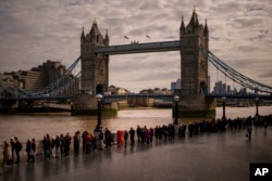 People queue near London Bridge to pay their respects to late Queen Elizabeth II, , at Westminster Hall in London.