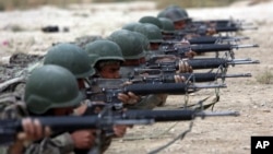 FILE - In this Oct. 31, 2018, file photo, Afghan National Army soldiers participate in a live fire training exercise, at the Afghan Military Academy, in Kabul, Afghanistan.