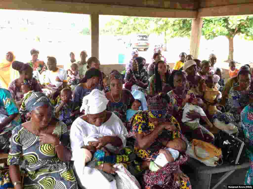 Mothers and babies wait patiently for immunizations at an open air clinic in Benin. (Sunpreet Arora) 