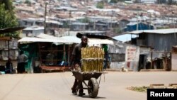 FILE - A vendor sells sugar cane in Kibera slum, home to over 1 million people, in Kenya's capital Nairobi. Taken March 7, 2014.