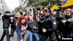Police officers scuffle with a group of protesters, who attempted to defy a ban and march on Taksim Square to celebrate May Day, in Istanbul, Turkey, May 1, 2022.
