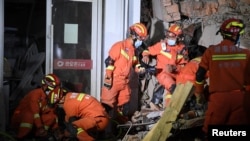 Rescue workers work at a site where a building collapsed in Changsha, Hunan province, China, April 29, 2022.