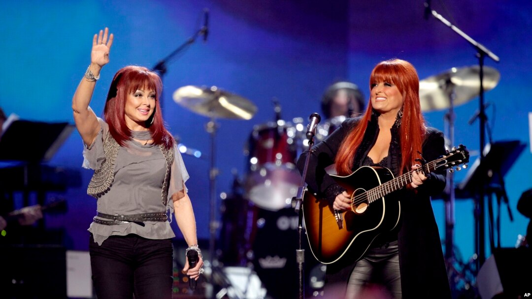 FILE - Naomi Judd, left, and Wynonna Judd, of The Judds, perform at the "Girls' Night Out: Superstar Women of Country," in Las Vegas, April 4, 2011.