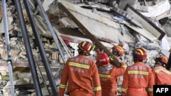 Rescuers search for survivors at a collapsed six-story building in Changsha, China, April 29, 2022.