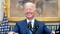 FILE - President Joe Biden smiles while speaking in the Roosevelt Room at the White House, April 28, 2022, in Washington.