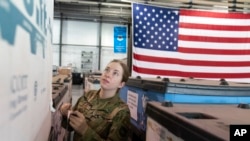 U.S. Air Force Airman Megan Konsmo, from Tacoma, Wash., checks pallets of equipment ultimately bound for Ukraine in the Super Port of the 436th Aerial Port Squadron, April 29, 2022, at Dover Air Force Base, Del.