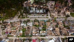 Destroyed houses are photographed in Irpin, on the outskirts of Kyiv, Ukraine, April 30, 2022.