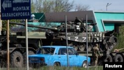 A captured Russian tank is transported on a trailer platform by the Ukrainian army on a road outside Dnipro, Ukraine, April 30, 2022. 