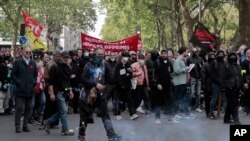 Demonstrators hold a banner reading : "Proletarians and oppressed peoples of all countries, unite" during a May Day demonstration march from Republique, Bastille to Nation, in Paris, France, May 1, 2022. 