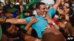 FILE - Karim Tabbou, one of the most prominent if not the best-known figure of the Hirak pro-democracy movement, is greeted upon his release from prison on July 2, 2020, outside the Kolea Prison near the city of Tipasa, Algeria.