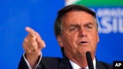 FILE - Brazil's President Jair Bolsonaro speaks during a meeting with parliamentarians at the Planalto Presidential Palace, in Brasilia, April 27, 2022.