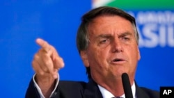 FILE - Brazil's President Jair Bolsonaro speaks during a meeting with parliamentarians at the Planalto Presidential Palace, in Brasilia, April 27, 2022.