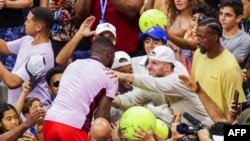 Frances Tiafoe jumps into the stands to celebrate after defeating Rafael Nadal in their 2022 U.S. Open tennis tournament match at the USTA Billie Jean King National Tennis Center in New York, on Sept. 5, 2022.