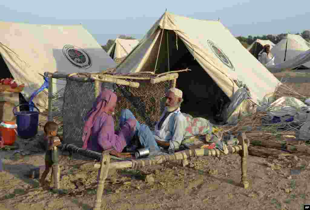 A family take refuge after heavy rains in Sohbat Pur city, a district of Pakistan's southwestern Baluchistan province, Sept. 4, 2022.