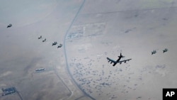 This photo released by the U.S. Air Force shows a B-52H Stratofortress assigned to the 5th Bomb Wing, Minot Air Force Base, North Dakota, flying over the Middle East, Sept. 4, 2022. 