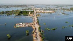 This aerial photograph shows makeshift tents for people displaced due to the floods after heavy monsoon rains at Sohbatpur in Jaffarabad district of Balochistan province, Sept. 4, 2022.