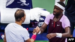 Frances Tiafoe of the U.S. and Spain's Rafael Nadal shake hands after Tiafoe won their 2022 U.S. Open tennis tournament match at the USTA Billie Jean King National Tennis Center in New York on Sept. 5, 2022. 