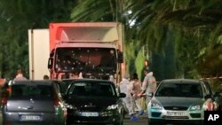 FILE - The truck that slammed into revelers on July 14, 2016, is seen near the site of an attack in the French resort city of Nice, July 15, 2016.