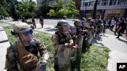 U.S. Army members form a police line on 16th Street as demonstrators gather to protest the death of George Floyd, Wednesday, June 3, 2020, near the White House in Washington. Floyd died after being restrained by Minneapolis police officers. (AP…