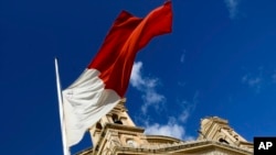 The Maltese flag flies at half-must during the funeral services for Daphne Caruana Galizia, an investigative journalist killed by a car bomb, in Valletta, Malta, Friday, Nov. 3, 2017. Malta observed a national day of mourning Friday as the Mediterranean island's largest church h