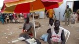 FILE - A money changer waits to do business at his open-air stall at a market in Juba, South Sudan, April 9, 2007. 