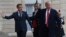 President Donald Trump is greeted by French President Emmanuel Macron after arriving at the Elysee Palace in Paris, Nov. 10, 2018. 