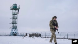 A Ukrainian border guard patrols the border with Russia not far from Hoptivka village, Kharkiv region, Ukraine, Feb. 2, 2022.