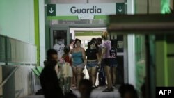 Relatives of people hospitalized after using cocaine cut with a toxic substance are seeen at San Bernardino Hospital in Hurlingham, Argentina, Feb. 2, 2022.