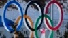 A person stands in the Olympic Rings during a cross-country skiing training session before the 2022 Winter Olympics, Feb. 3, 2022, in Zhangjiakou, China. 