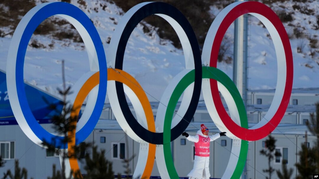 A person stands in the Olympic Rings during a cross-country skiing training session before the 2022 Winter Olympics, Feb. 3, 2022, in Zhangjiakou, China. 