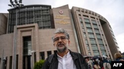 FILE - Erol Onderoglu, Reporters Without Borders (RSF) representative in Turkey, speaks to the press in front of Istanbul's courthouse before his trial on charges of making terror propaganda for Kurdish militants, Sept. 30, 2021.