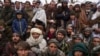 FILE - Hundreds of Afghan men gather to apply for humanitarian aid, in Qala-e-Naw, Afghanistan, Dec. 14, 2021.