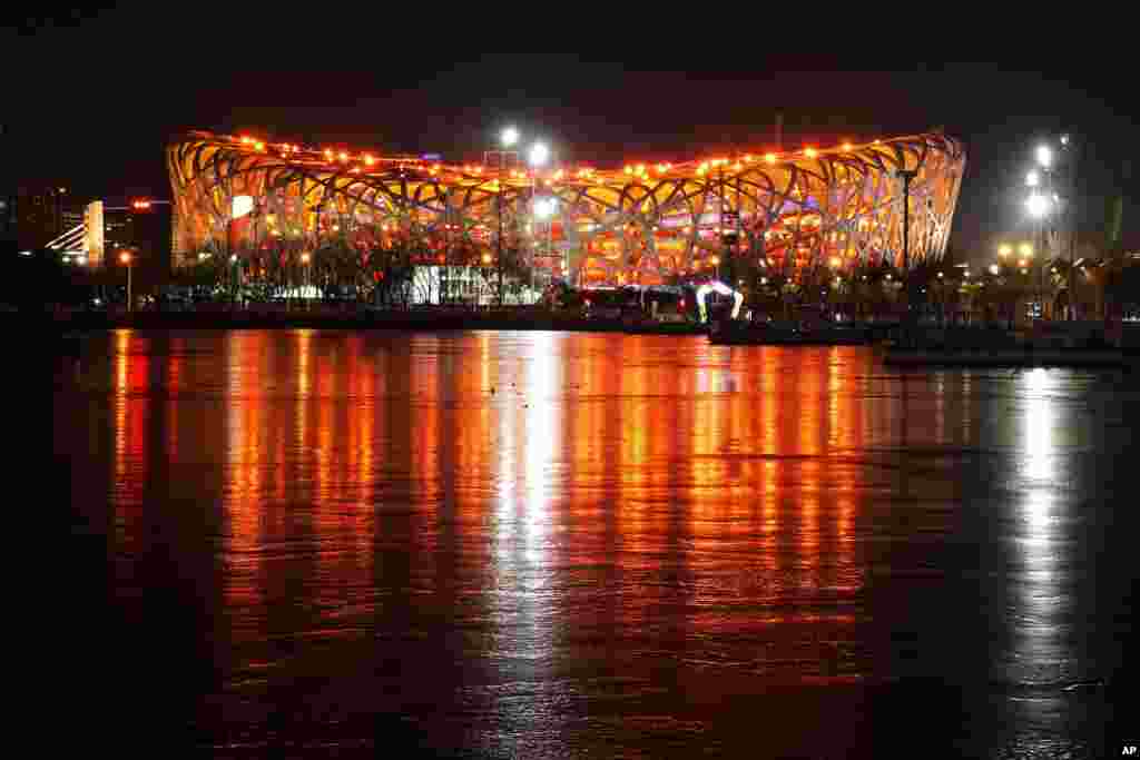 The Olympic Stadium is lit prior to the opening ceremony of the 2022 Winter Olympics, Feb. 4, 2022, in Beijing.